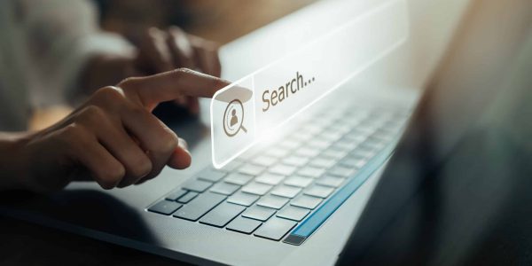 Hand using laptop and press screen to search Browsing on the Internet online.