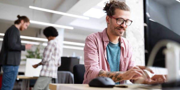 Programmer working and developing software in office on computer