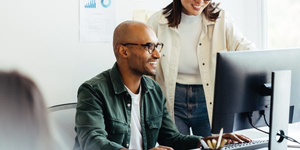 Web developers using a computer to optimize website speed and performance.